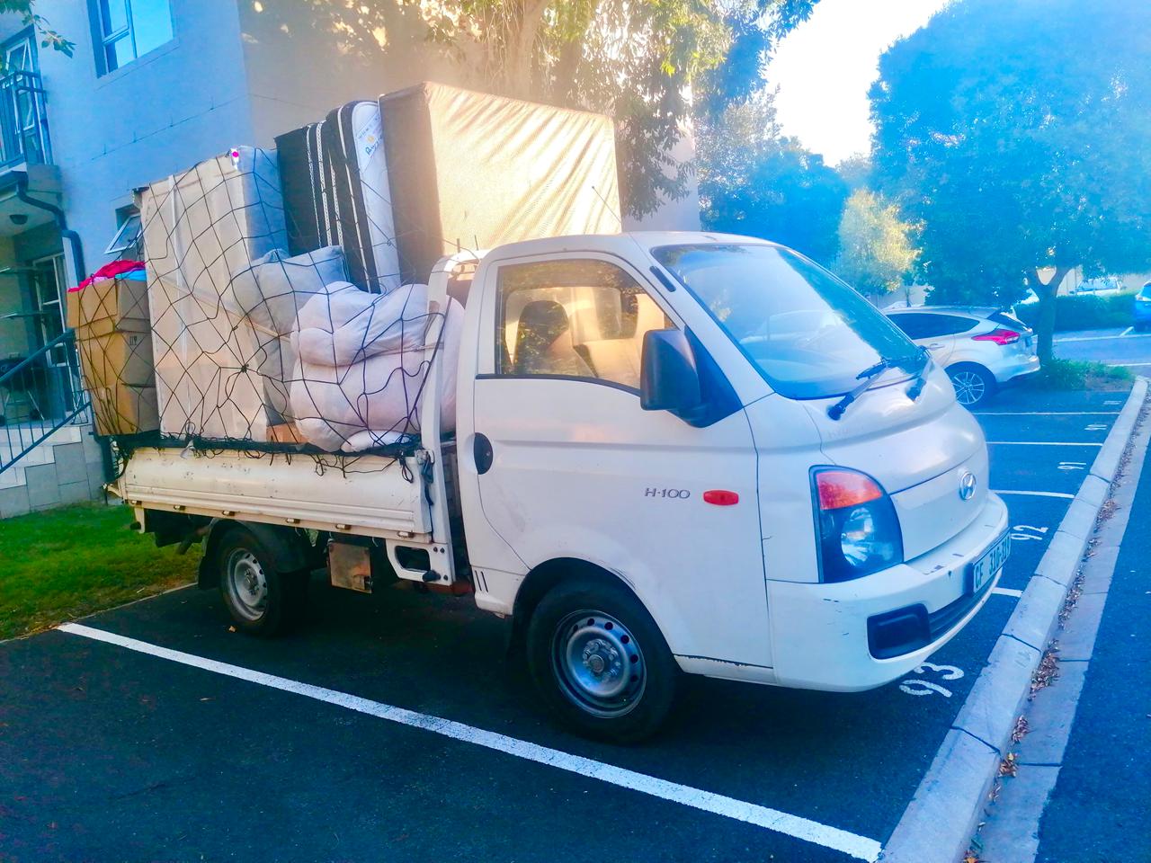 Netted removals bakkie leaving a residential complex